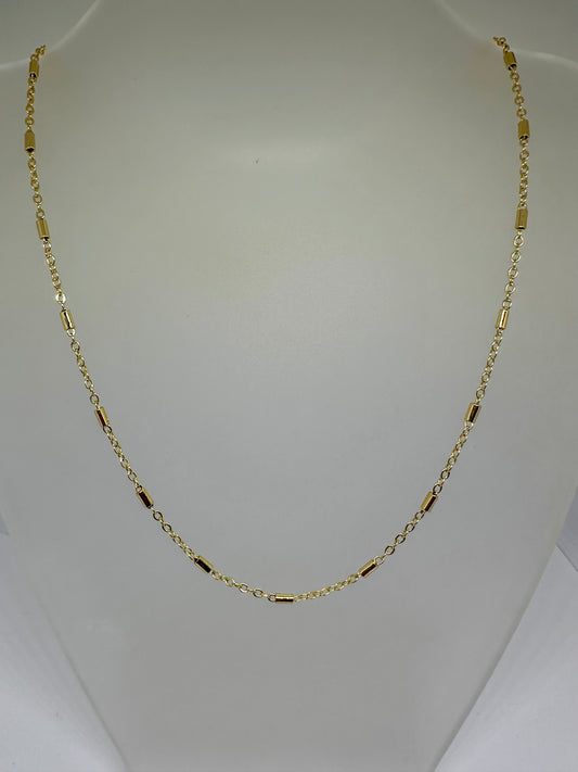 Gold chain necklace on a white background.
